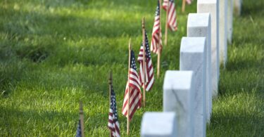 American flags in front of tombstones at Arlington National Cemetery for Memorial Day