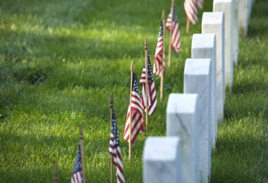 American flags in front of tombstones at Arlington National Cemetery for Memorial Day