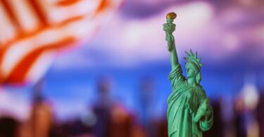 Statue of Liberty with flag of the United States of America at New York City