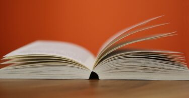 selective focus photography of white softbound book
