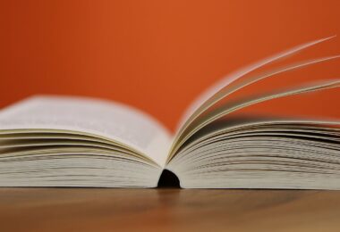 selective focus photography of white softbound book