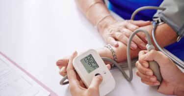 Measuring blood pressure of elderly woman