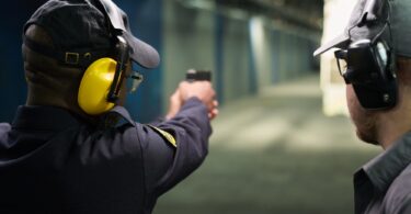 Practicing Shooting at Indoor Shooting Range with Handgun