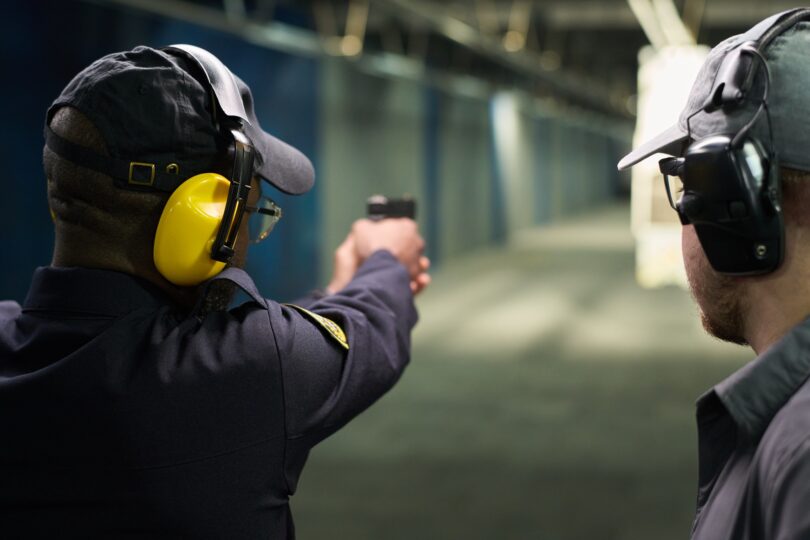 Practicing Shooting at Indoor Shooting Range with Handgun