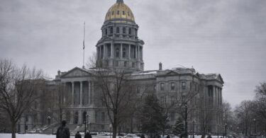 Colorado State Capitol in Denver with people walking outside on a winter day