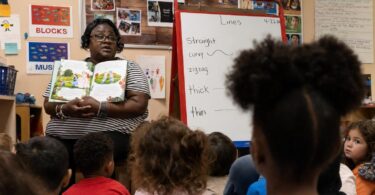 Colorado preschool classroom with young children and a teacher during group learning