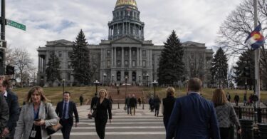 Colorado State Capitol in Denver with people outside during a legislative day