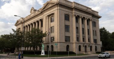 Weld County public meeting room with officials discussing Justice Center voters issue